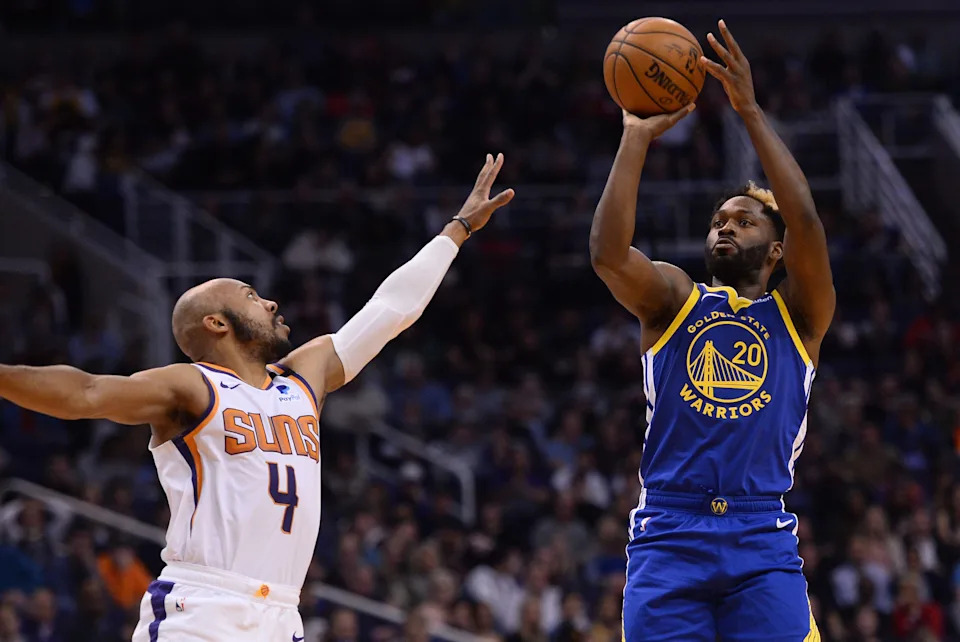 Feb 12, 2020; Phoenix, Arizona, USA; Golden State Warriors guard Jeremy Pargo (20) shoots over Phoenix Suns guard Jevon Carter (4) during the second half at Talking Stick Resort Arena. Mandatory Credit: Joe Camporeale-USA TODAY Sports
