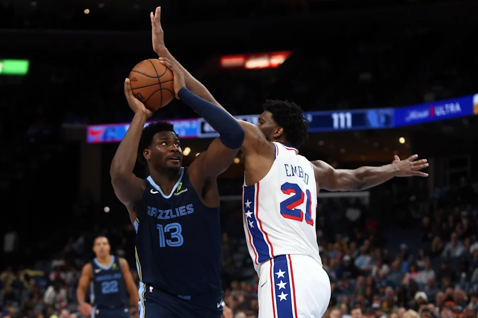 Nov 20, 2024; Memphis, Tennessee, USA; Memphis Grizzlies forward Jaren Jackson Jr. (13) drives to the basket as Philadelphia 76ers center Joel Embiid (21) defends during the second half at FedExForum. Mandatory Credit: Petre Thomas-Imagn Images