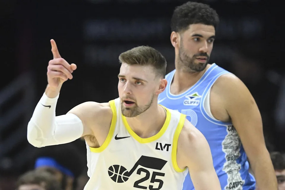 Dec 23, 2024; Cleveland, Ohio, USA; Utah Jazz center Micah Potter (25) celebrates his three-point goal beside Cleveland Cavaliers forward Georges Niang (20) in the first quarter at Rocket Mortgage FieldHouse. Mandatory Credit: David Richard-Imagn Images
