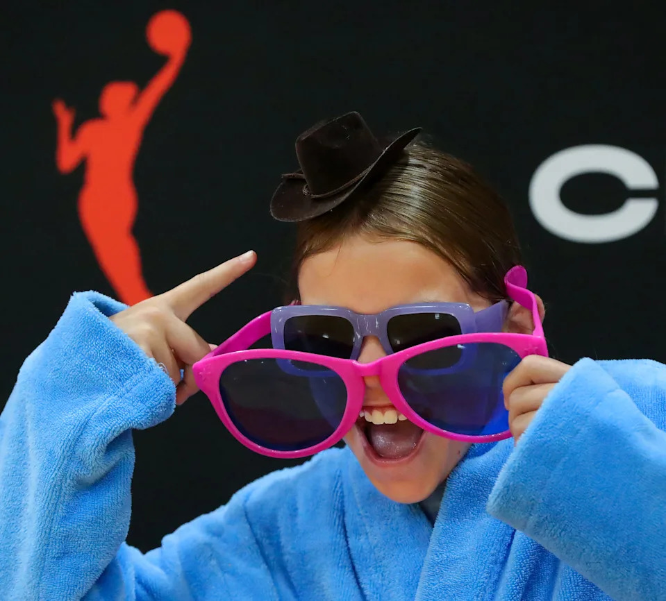 Ellora McKay of Aurora poses for pictures July 31 on the orange carpet before a WNBA-themed girls basketball camp held at Aurora High School.