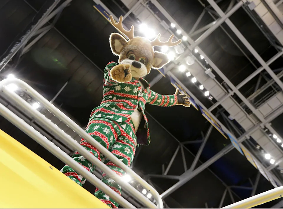 Bango, the Milwaukee Bucks' mascot, sports a festive holiday suit while posing for the camera at Fiserv Forum in Milwaukee on Tuesday, Dec. 22, 2020. While preparations were underway for the home opener on Christmas Day, only a few dozen people inside the arena will see the whole production when Fiserv Forum opens for the first time for the Bucks 2020-'21 season.