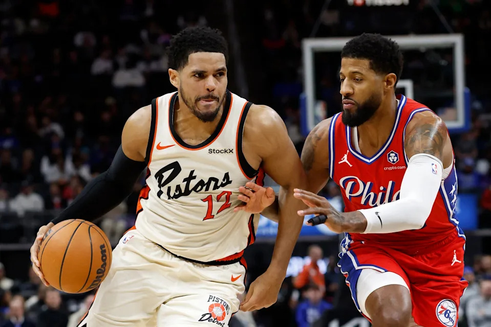 Feb 7, 2025; Detroit, Michigan, USA; Detroit Pistons forward Tobias Harris (12) dribbles defended by Philadelphia 76ers forward Paul George (8) in the second half at Little Caesars Arena. Mandatory Credit: Rick Osentoski-Imagn Images