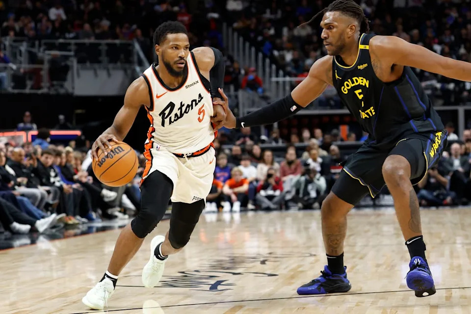 Jan 9, 2025; Detroit, Michigan, USA; Detroit Pistons guard Malik Beasley (5) dribbles defended by Golden State Warriors forward Kevon Looney (5) in the first half at Little Caesars Arena. Mandatory Credit: Rick Osentoski-Imagn Images