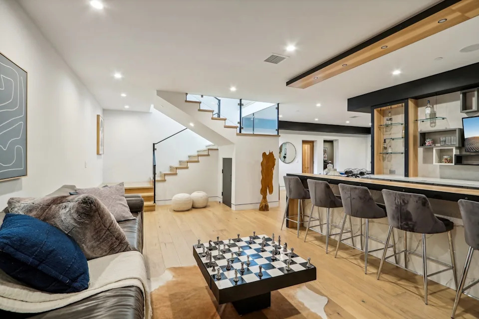 Inside, there are floor-to-ceiling windows and wide-plank floors that emphasize the home's open floor plan.