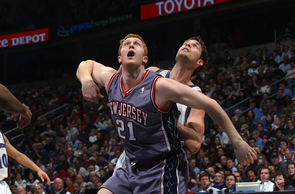WASHINGTON - FEBRUARY 21: Brian Scalabrine #21 of the New Jersey Nets and Christian Laettner #44 of the Washington Wizards battle for position during the NBA game at MCI Center on February 21, 2003 in Washington, D.C. The Wizards won 89-86. NOTE TO USER: User expressly acknowledges and agrees that, by downloading and or using this Photograph, User is consenting to the terms and conditions of the Getty Images License Agreement. (Photo by Doug Pensinger/Getty Images)