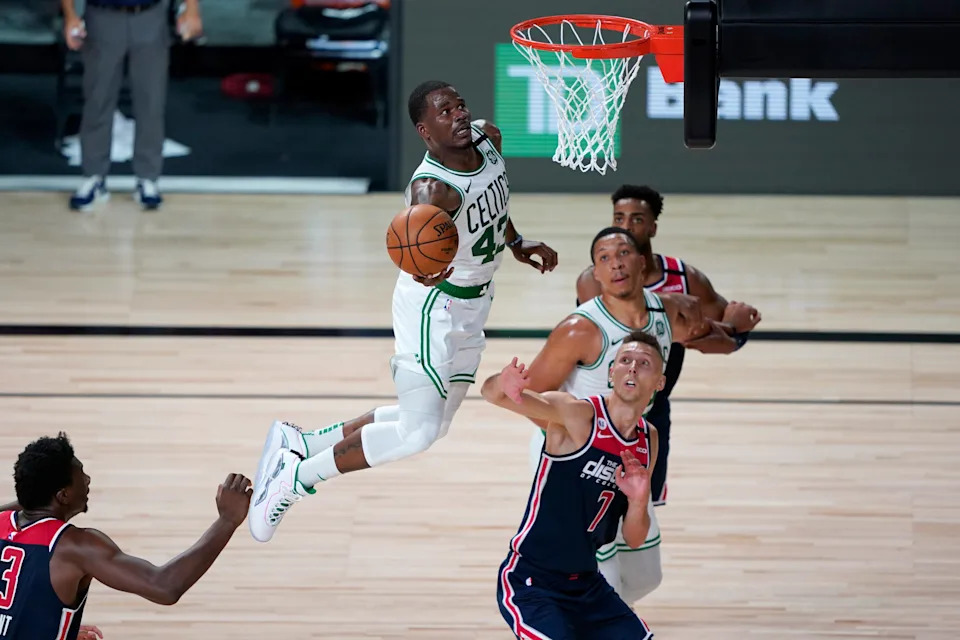 Aug 13, 2020; Lake Buena Vista, Florida, USA; Boston Celtics' Javonte Green (43) heads to the basket as Washington Wizards' Jarrod Uthoff (7) defends during the second half of an NBA basketball game Thursday, Aug. 13, 2020 in Lake Buena Vista, Fla. at ESPN Wide World of Sports Complex. Mandatory Credit: Ashley Landis/Pool Photo-USA TODAY Sports
