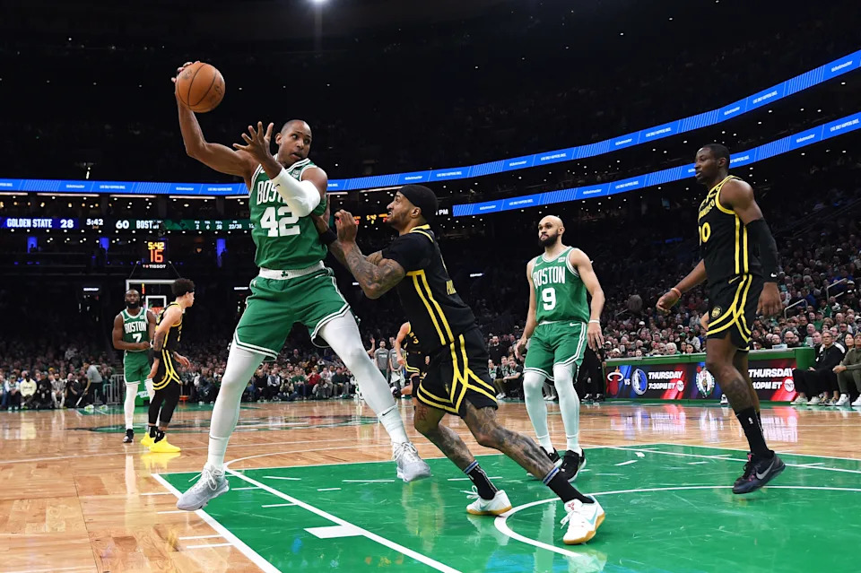 Mar 3, 2024; Boston, Massachusetts, USA; Boston Celtics center Al Horford (42) controls the ball while Golden State Warriors guard Gary Payton II (0) defends during the first half at TD Garden. Mandatory Credit: Bob DeChiara-USA TODAY Sports