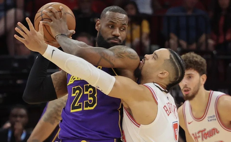 Los Angeles Lakers forward LeBron James (23) defends the ball from Houston Rockets forward Dillon Brooks (9)Mandatory Credit: Thomas Shea-Imagn Images