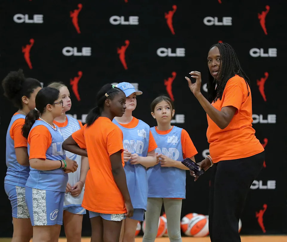 Former Cleveland Rockers player Janice Braxton motivates a group of girls before they take on the coaches during a WNBA-themed girls basketball camp July 31, 2025, at Aurora High School.