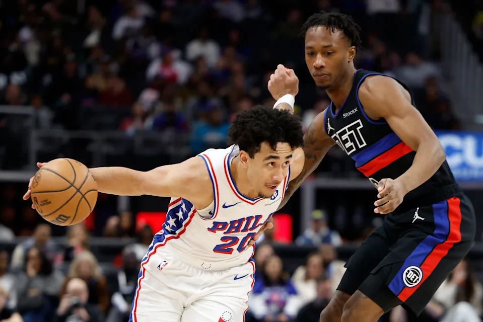 Nov 30, 2024; Detroit, Michigan, USA; Philadelphia 76ers guard Jared McCain (20) dribbles on Detroit Pistons forward Ronald Holland II (00) in the first half at Little Caesars Arena. Mandatory Credit: Rick Osentoski-Imagn Images