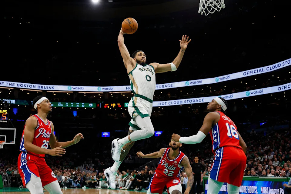 Feb 27, 2024; Boston, Massachusetts, USA; Boston Celtics forward Jayson Tatum (0) goes in for a dunk as Philadelphia 76ers forward Darius Bazley (25) and guard Ricky Council IV (16) look on during the second half at TD Garden. Mandatory Credit: Winslow Townson-USA TODAY Sports