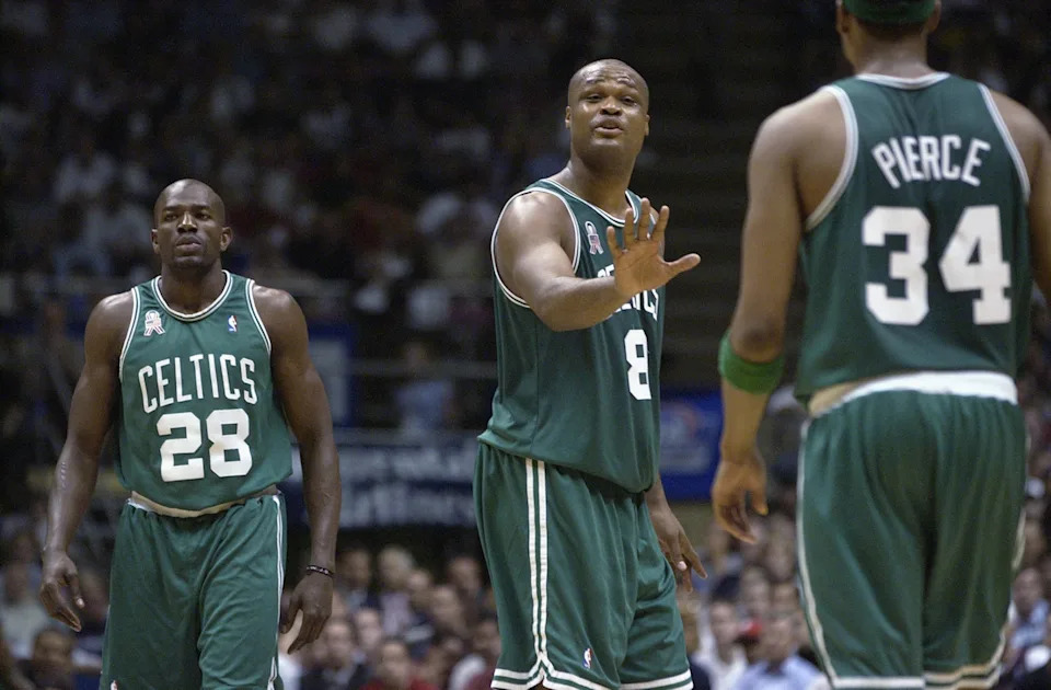 EAST RUTHERFORD, NJ - MAY 29: Forward Antoine Walker #8 of the Boston Celtics reassures forward Paul Pierce #34 as guard Tony Delk #28 walks by in Game five of the Eastern Conference Finals against the New Jersey Nets during the 2002 NBA Playoffs at Continental Airlines Arena in East Rutherford, New Jersey on May 29, 2002. The Nets won 103-92. NOTE TO USER: User expressly acknowledges and agrees that, by downloading and/or using this Photograph, User is consenting to the terms and conditions of the Getty Images License Agreement Mandatory Copyright Notice: Copyright 2002 NBAE (Photo by Ezra Shaw/Getty Images)