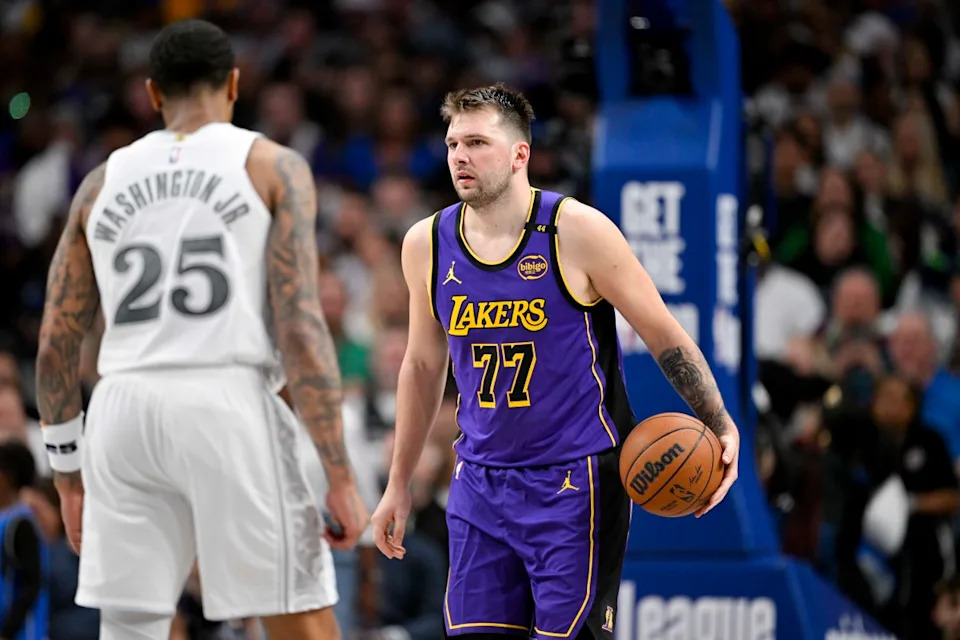 Dallas Mavericks forward P.J. Washington and Los Angeles Lakers guard Luka Doncic.© Jerome Miron-Imagn Images