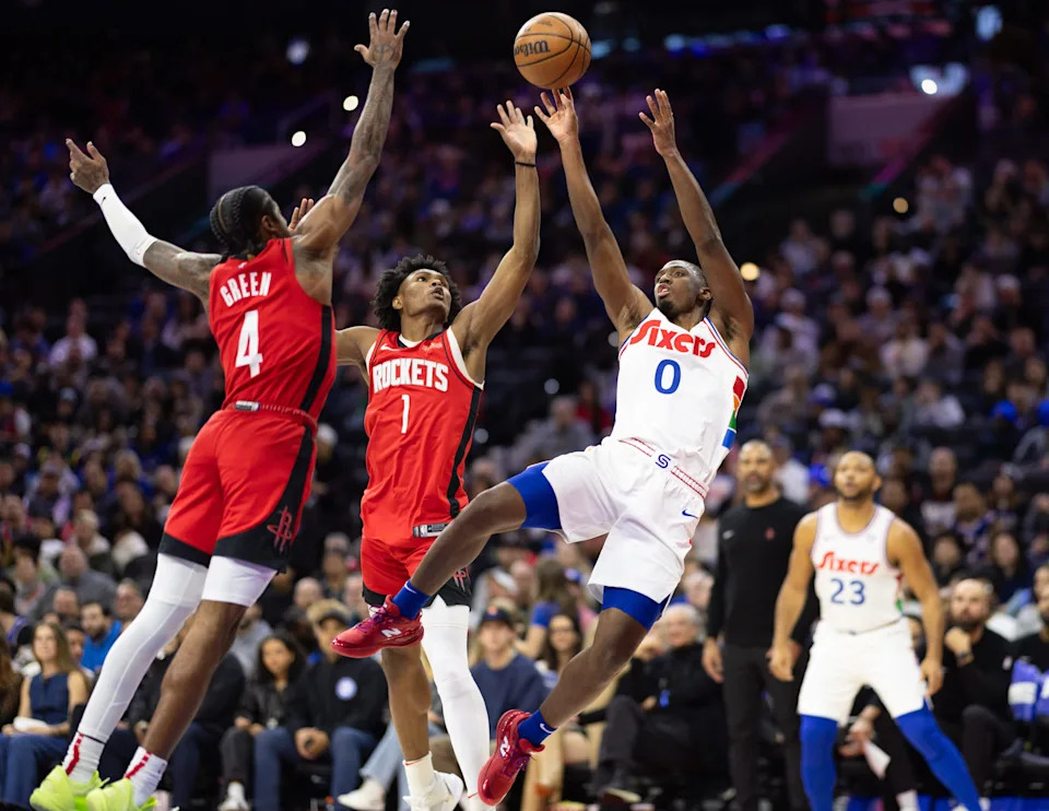Nov 27, 2024; Philadelphia, Pennsylvania, USA; Houston Rockets guard Jalen Green (4) and forward Amen Thompson (1) Philadelphia 76ers guard Tyrese Maxey (0) shoots the ball in front of during the first quarter at Wells Fargo Center. Mandatory Credit: Bill Streicher-Imagn Images