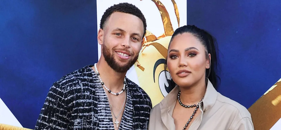 Ayesha Curry and Steph Curry posing on the red carpet.