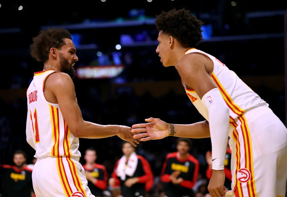 LOS ANGELES, CALIFORNIA - JANUARY 03: Trae Young #11 of the Atlanta Hawks celebrates the basket with a Los Angeles Lakers foul with Jalen Johnson #1 during the first half at Crypto.com Arena on January 03, 2025 in Los Angeles, California. NOTE TO USER: User expressly acknowledges and agrees that, by downloading and or using this photograph, User is consenting to the terms and conditions of the Getty Images License Agreement. (Photo by Harry How/Getty Images)