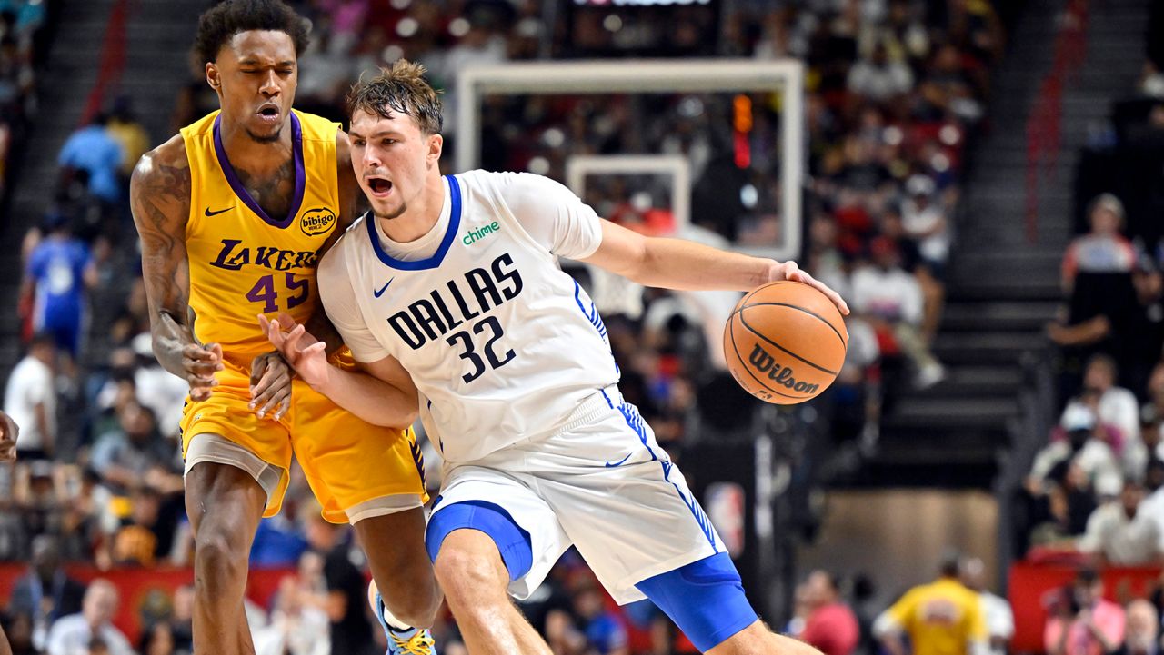 Dallas Mavericks forward Cooper Flagg (32) drives the ball against Los Angeles Lakers guard DaJaun Gordon (45) during the second half of an NBA summer league basketball game Thursday, July 10, 2025, in Las Vegas. (AP Photo/David Becker)