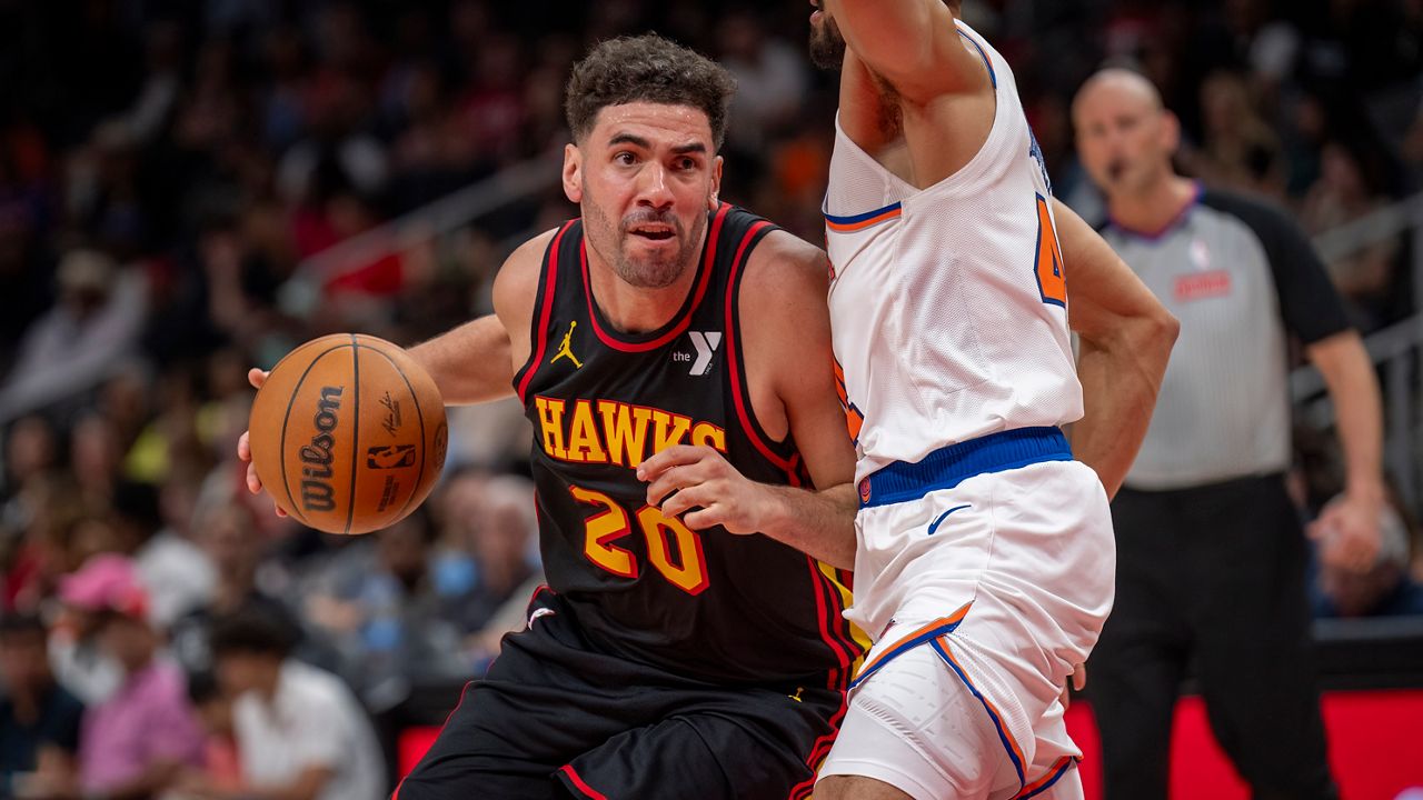 FILE - Atlanta Hawks forward Georges Niang, left, drives the ball down court against New York Knicks guard Landry Shamet, during the second half of an NBA basketball game, April 5, 2025, in Atlanta. (AP Photo/Erik Rank, File)