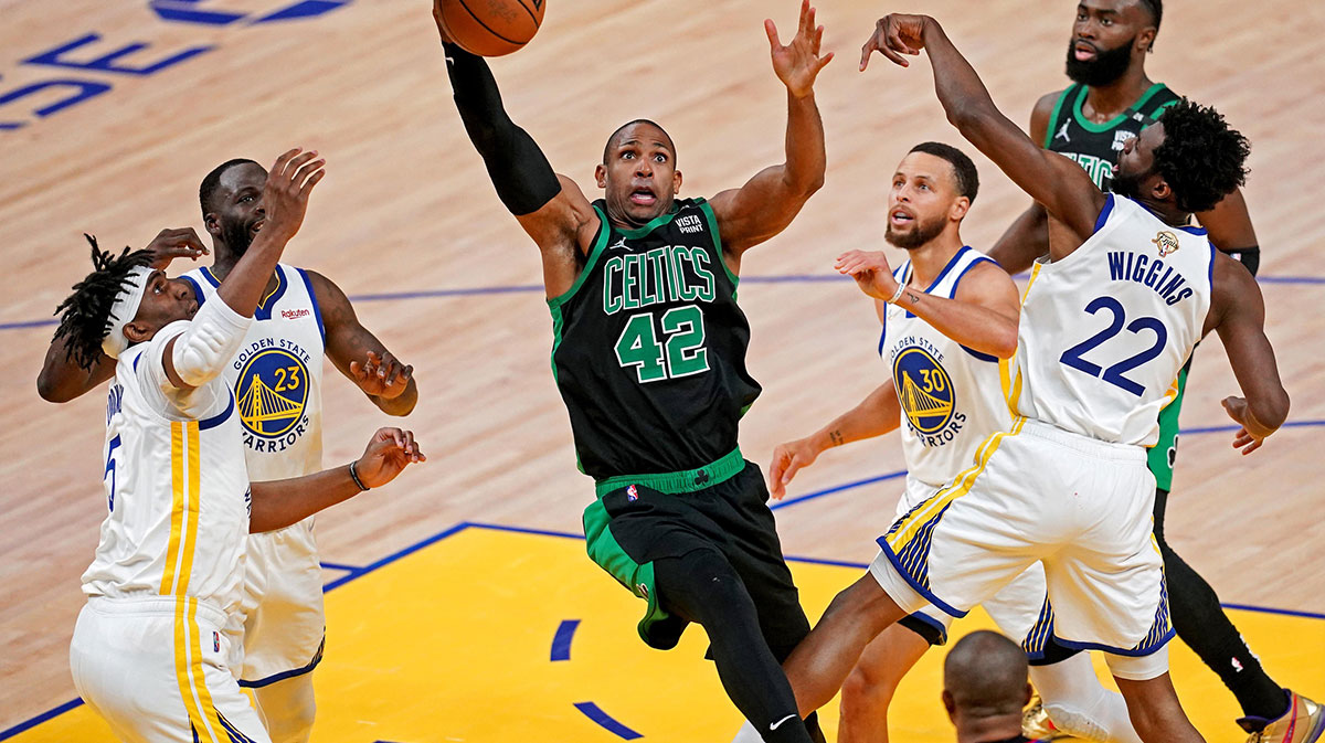 Boston Celtics center Al Horford (42) grabs a rebound against Golden State Warriors forward Andrew Wiggins (22) during the first quarter in game five of the 2022 NBA Finals at Chase Center.