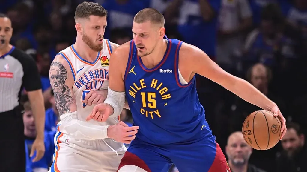 Nikola Jokic #15 of the Denver Nuggets posts up against Isaiah Hartenstein #55 of the Oklahoma City Thunder.