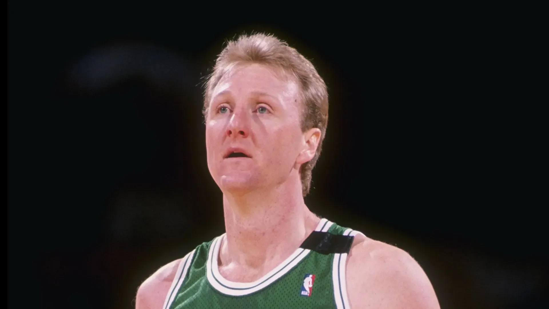 Forward Larry Bird of the Boston Celtics stands on the court during a game.