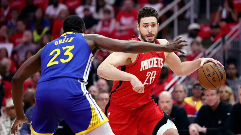 Alperen Sengun #28 of the Houston Rockets is defended by Draymond Green #23 of the Golden State Warriors during the NBA Playoffs. (Alex Slitz/Getty Images)