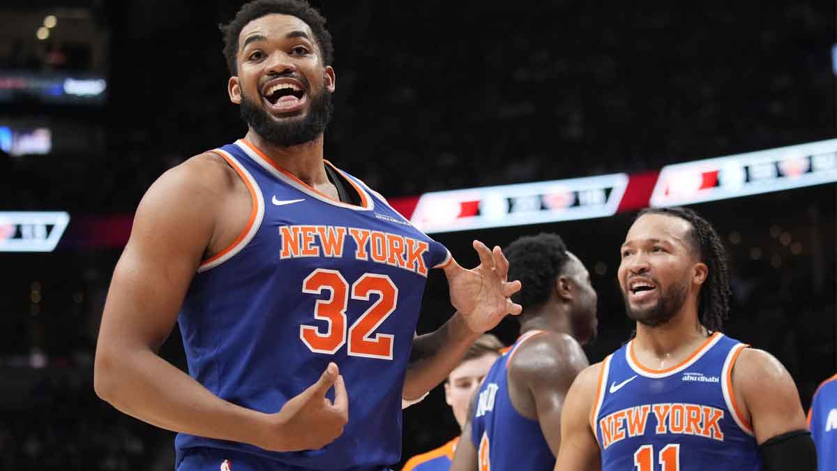 New York Knicks guard Jalen Brunson (11) watches as center Karl-Anthony Towns (32) celebrates after making a three point basket to clinch a win against the Toronto Raptors near the end of the fourth quarter at Scotiabank Arena.