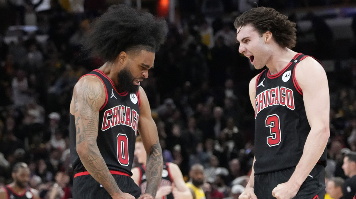 Chicago Bulls guard Coby White (0) celebrates his three point basket against the Los Angeles Lakers with guard Josh Giddey (3) during the second half at United Center.