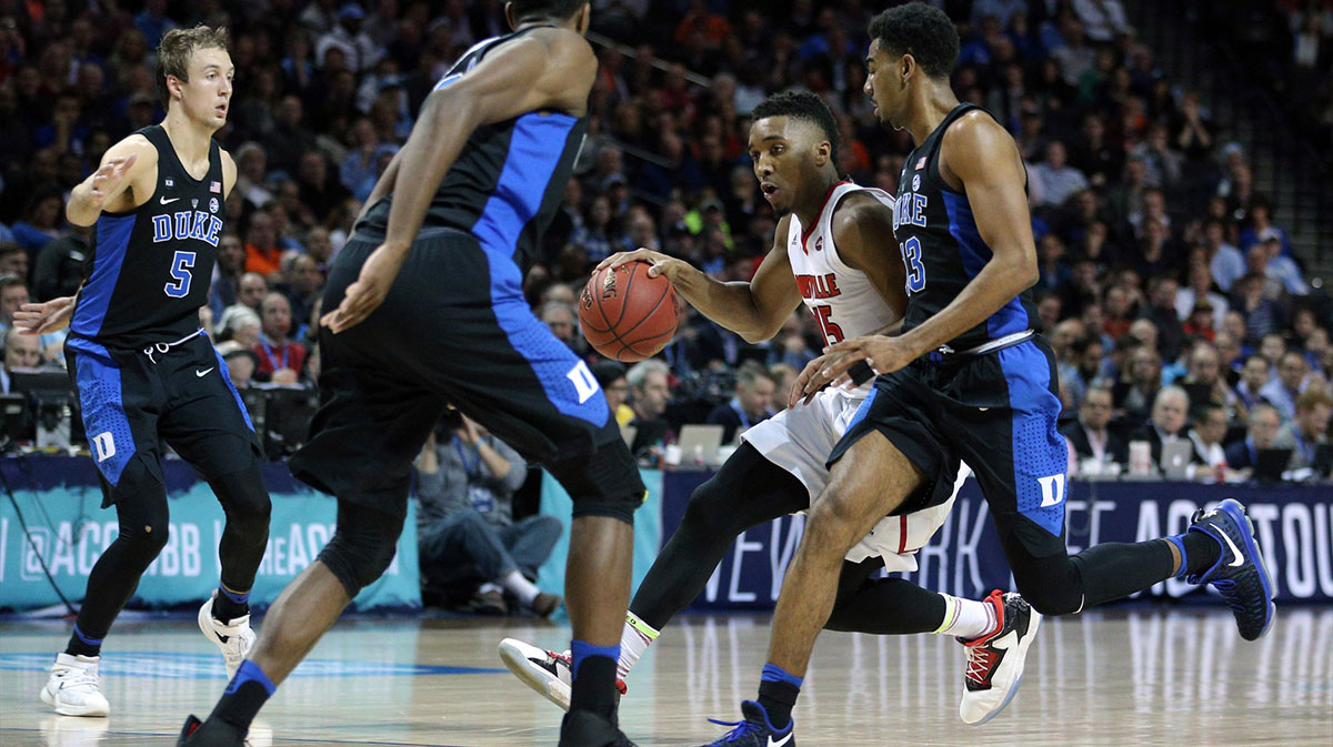 Louisville Cardinals guard Donovan Mitchell (45) drives against Duke Blue Devils guard Matt Jones (13) during the first half of an ACC Conference Tournament game at Barclays Center.