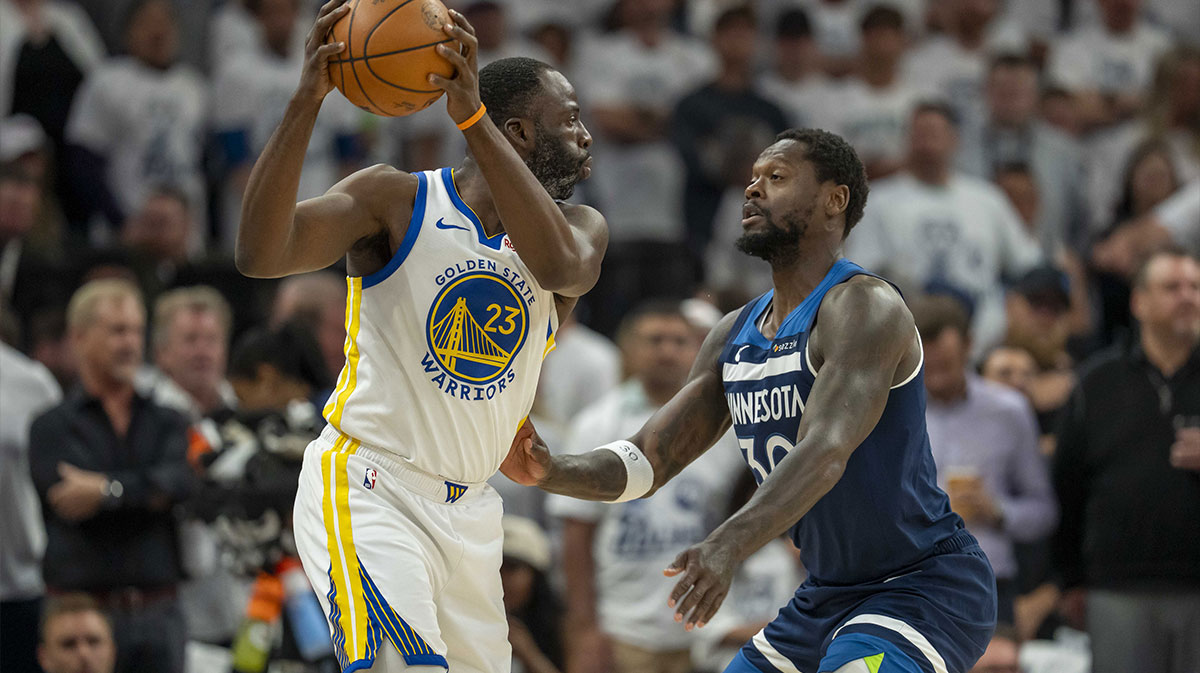 Golden State Warriors forward Draymond Green (23) holds the ball up as Minnesota Timberwolves forward Julius Randle (30) plays defense in the first half during game five of the second round for the 2025 NBA Playoffs at Target Center.
