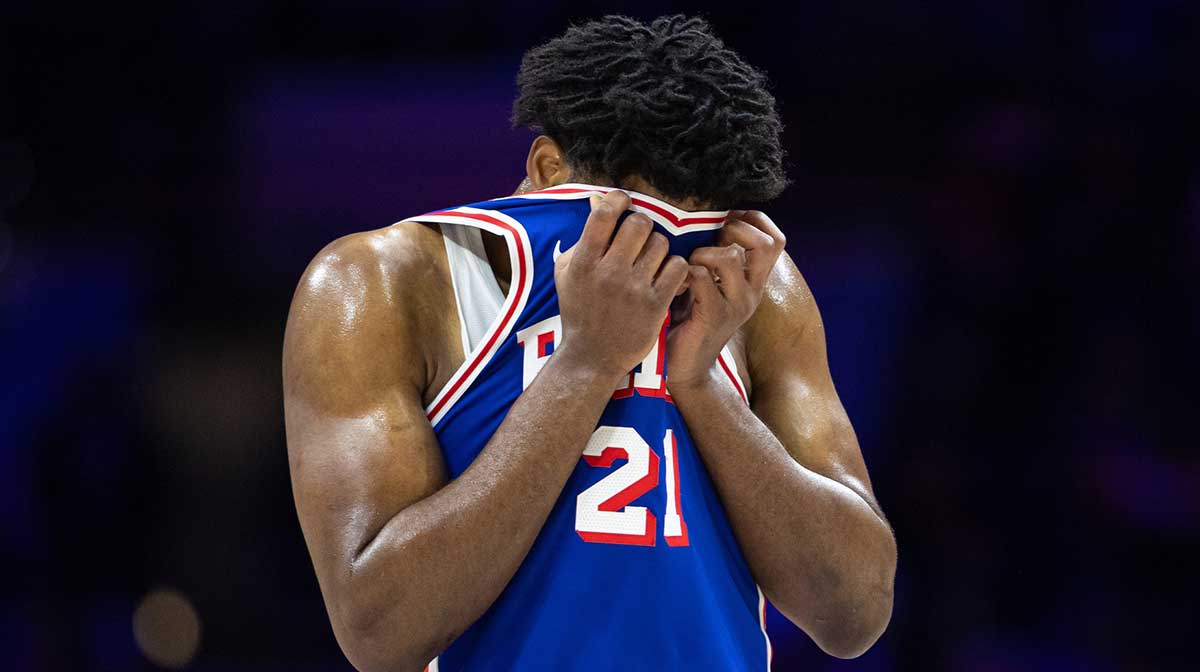 Philadelphia 76ers center Joel Embiid (21) wipes his face during a break in the third quarter against the Boston Celtics at Wells Fargo Center.
