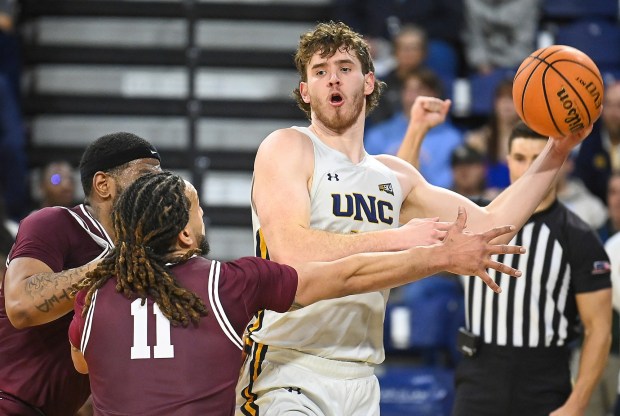 University of Northern Colorado junior Brock Wisne, right, looks to pass while playing Montana at Bank of Colorado Arena in Greeley on Thursday Feb. 6, 2025.(Jim Rydbom/Staff Photographer)