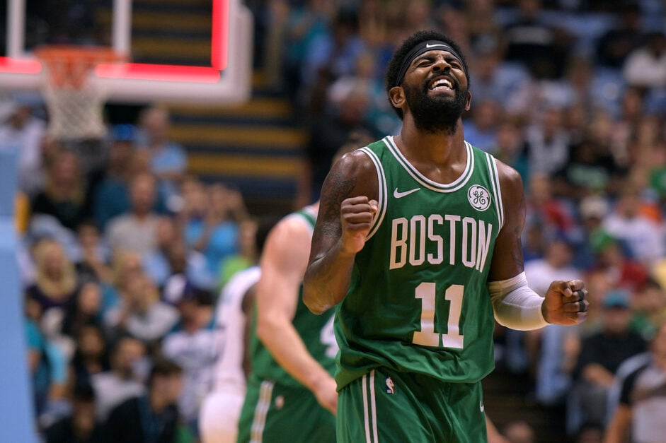 Boston Celtics point guard Kyrie Irving celebrates against the Charlotte Hornets