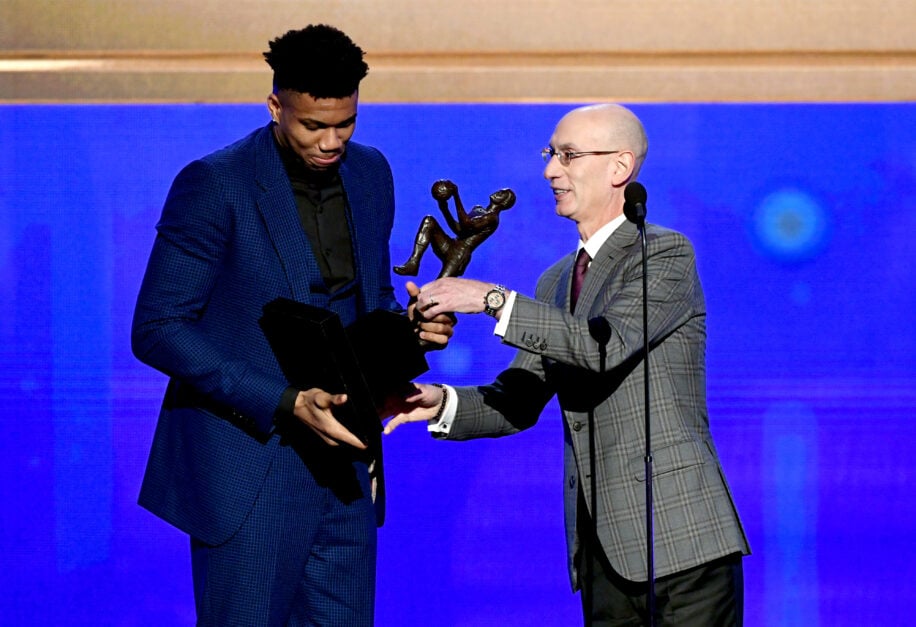 Giannis Antetokounmpo receiving the MVP trophy in 2019 from Adam Silver
