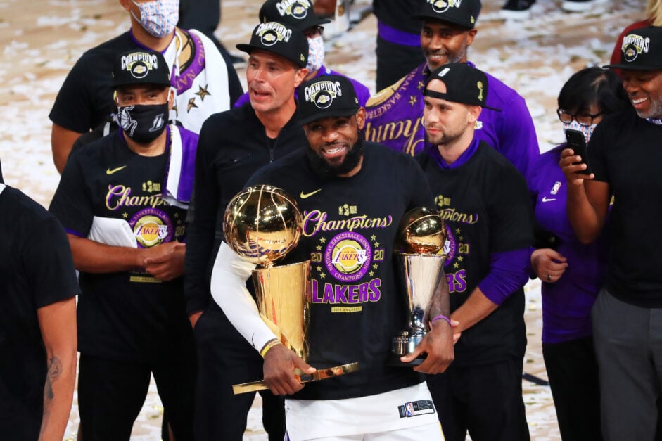LA Lakers' LeBron James reacts with his MVP trophy and Finals trophy after winning the 2020 NBA Championship