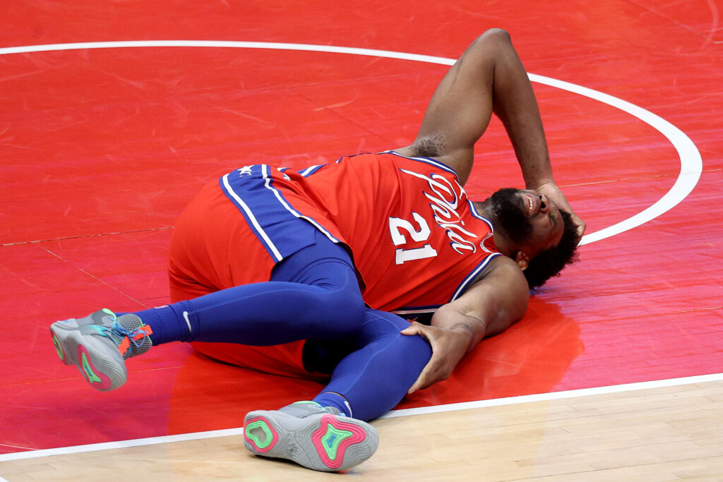 Joel Embiid #21 of the Philadelphia 76ers reacts after getting injured