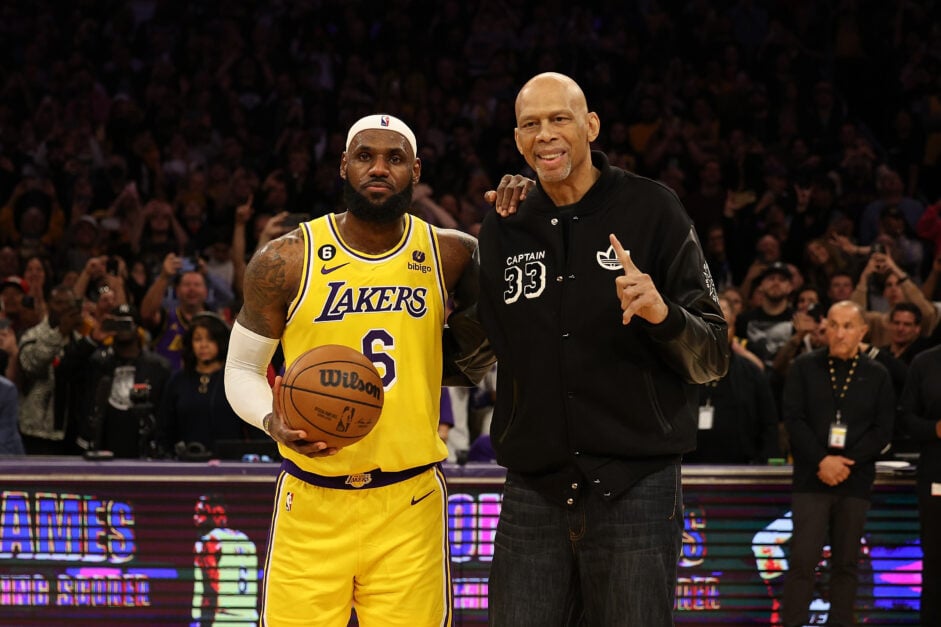 Kareem Abdul-Jabbar stands on court with LeBron James #6 of the Los Angeles Lakers after James passed Abdul-Jabbar to become the NBA's all-time leading scorer.