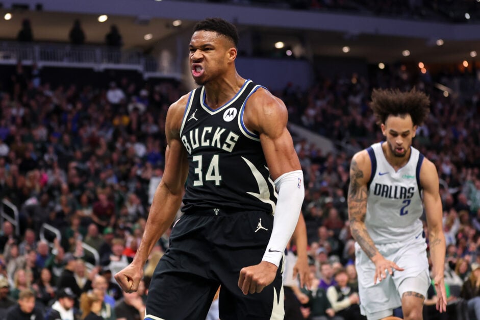 Giannis Antetokounmpo #34 of the Milwaukee Bucks reacts to a dunk against the Dallas Mavericks during the first half of a game at Fiserv Forum.