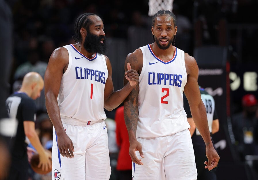 James Harden #1 and Kawhi Leonard #2 of the LA Clippers converse during a timeout in the fourth quarter against the Atlanta Hawks at State Farm Arena on February 05, 2024 in Atlanta, Georgia.