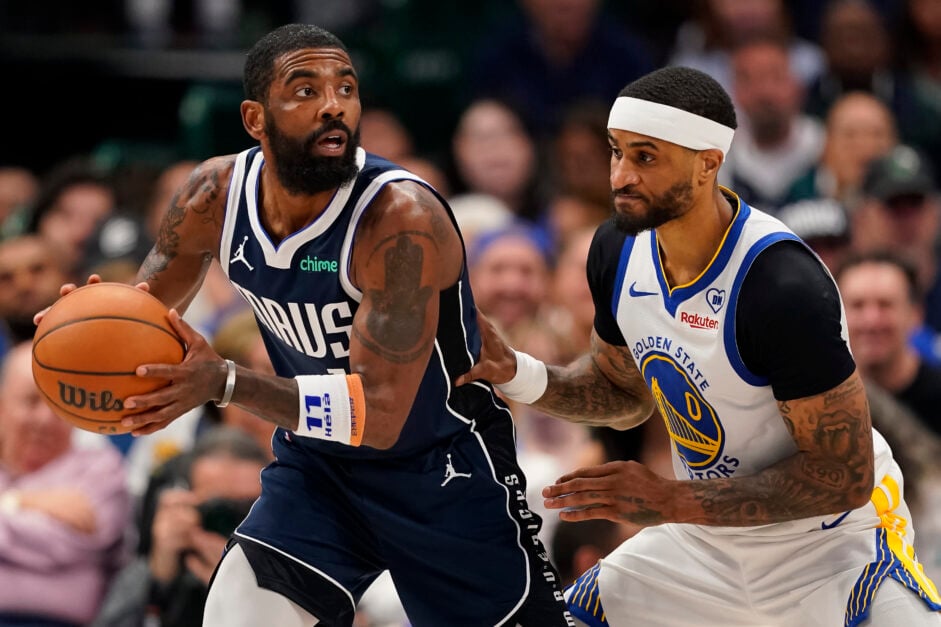 Kyrie Irving #11 of the Dallas Mavericks is defended by Gary Payton II #0 of the Golden State Warriors during the second half at American Airlines Center on April 05, 2024 in Dallas, Texas.