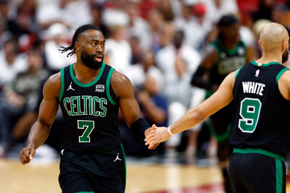 Jaylen Brown taps Derrick White's hand during Boston Celtics vs Miami Heat game.