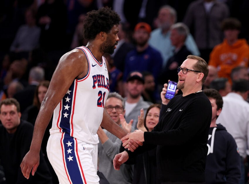 Joel Embiid #21 of the Philadelphia 76ers heads for the bench as he is greeted by Nick Nurse in the overtime period against the New York Knicks at Madison Square Garden on April 30, 2024 in New York City. The Philadelphia 76ers defeated the New York Knicks 112-106 in overtime.