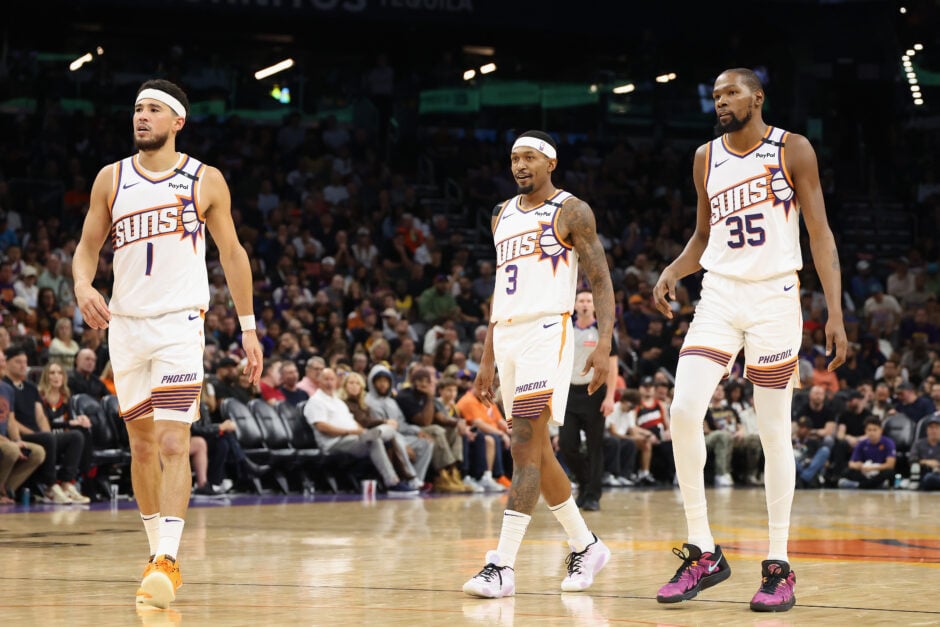 Devin Booker #1, Bradley Beal #3 and Kevin Durant #35 of the Phoenix Suns walk on the court