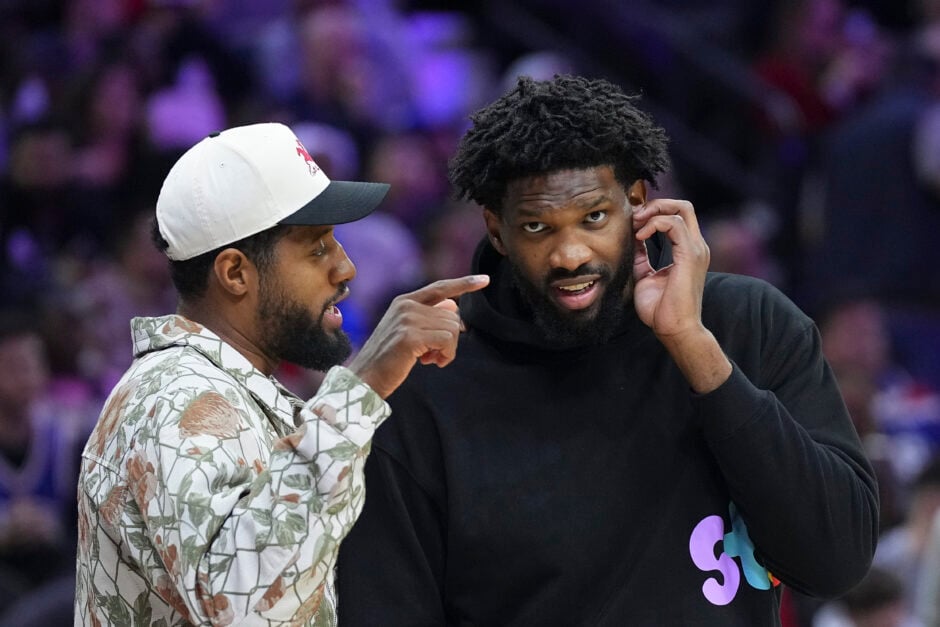 Philadelphia 76ers duo of Paul George and Joel Embiid talk during a game against the Memphis Grizzlies.