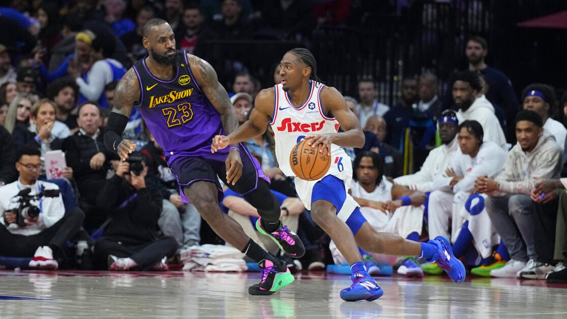 Tyrese Maxey #0 of the Philadelphia 76ers dribbles the ball against LeBron James #23 of the Los Angeles Lakers.