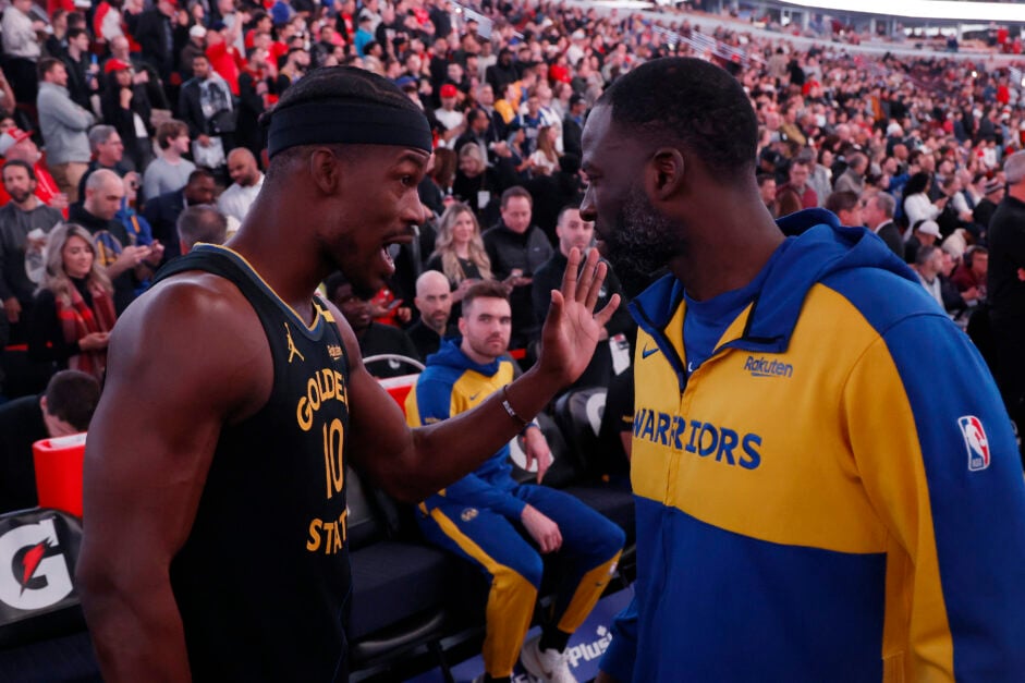 Jimmy Butler #10 of the Golden State Warriors talks with Draymond Green #23 prior to the game against the Chicago Bulls at the United Center on February 08, 2025 in Chicago, Illinois.