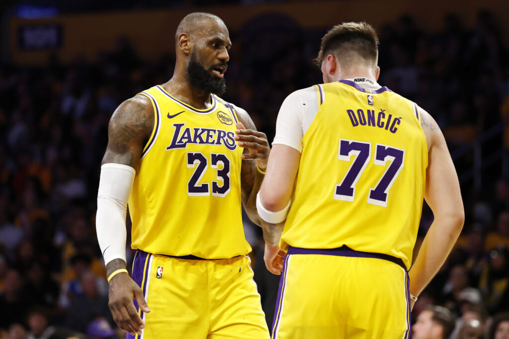 LeBron James #23 and Luka Doncic #77 of the Los Angeles Lakers talk
