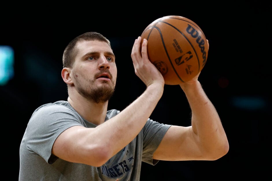 Nikola Jokic shoots in warm-up, grey t-shirt