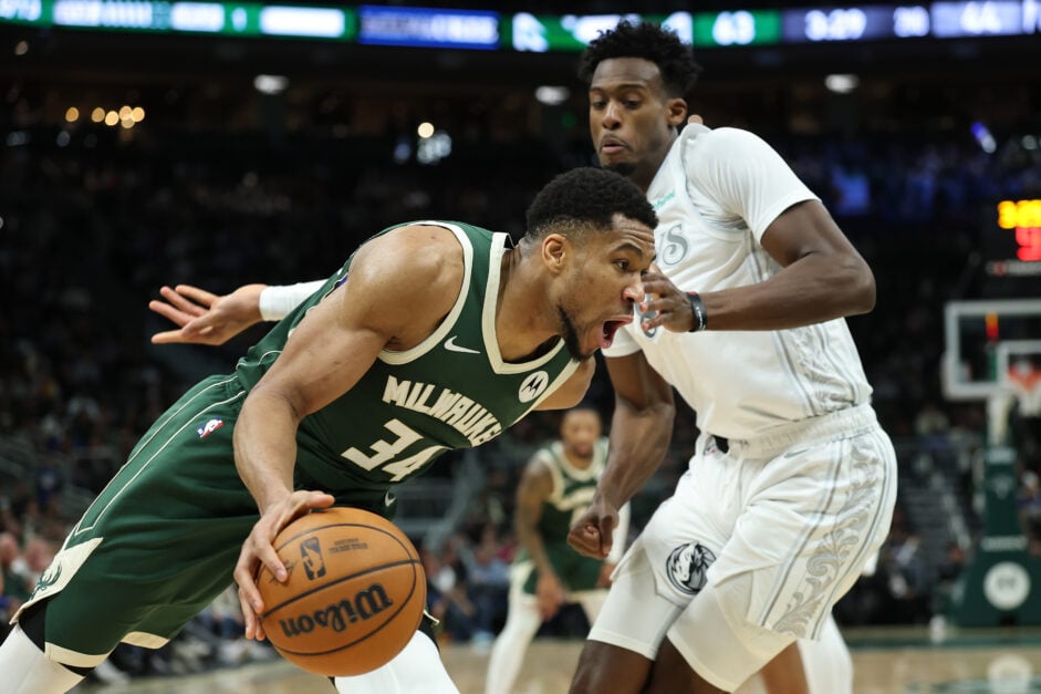 Giannis Antetokounmpo #34 of the Milwaukee Bucks drives around Olivier-Maxence Prosper #8 of the Dallas Mavericks during a game