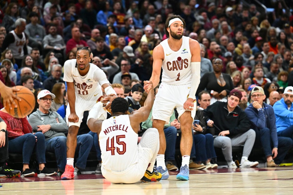 Darius Garland #10 and Max Strus #1 help Donovan Mitchell #45 of the Cleveland Cavaliers to his feet during the fourth quarter against the Orlando Magic at Rocket Arena on March 16, 2025 in Cleveland, Ohio.